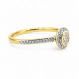 Elegance at first glance.This classic 9ct yellow gold bezel set oval natural diamond is surrounded by a halo and shoulders set with yet more sparkling diamonds.