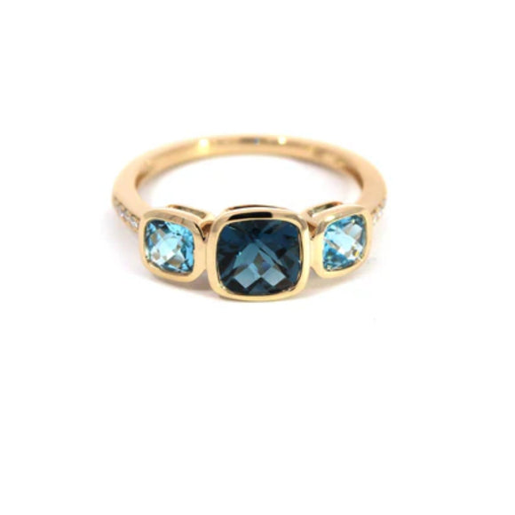 A 9ct yellow gold ring with a central blue topaz stone and additional light blue topazes on the sides, followed by diamonds on each shoulder.