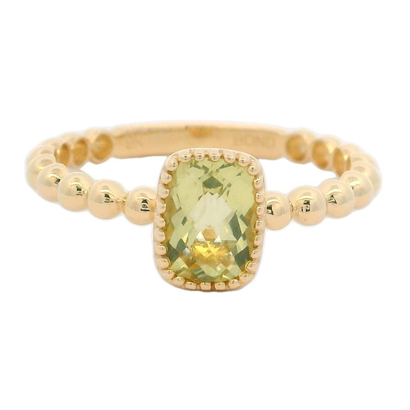 A cushion cut lemon quartz gemstone ring with a yellow gold band