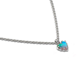 A silver chain necklace with a small heart-shaped pendant featuring a vibrant, iridescent opal gemstone that shifts between blue, green, and pink, set in a silver bezel.