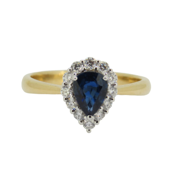 A pear-shaped sapphire ring with a halo of white diamonds set in yellow gold.