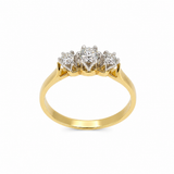 A yellow gold three-stone ring featuring a central round diamond flanked by two smaller round diamonds in a claw setting, shown on a plain white background.