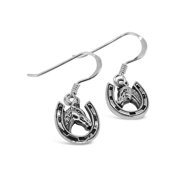 A pair of sterling silver drop earrings featuring a horsehead design inside a horseshoe with a hook fitting.
